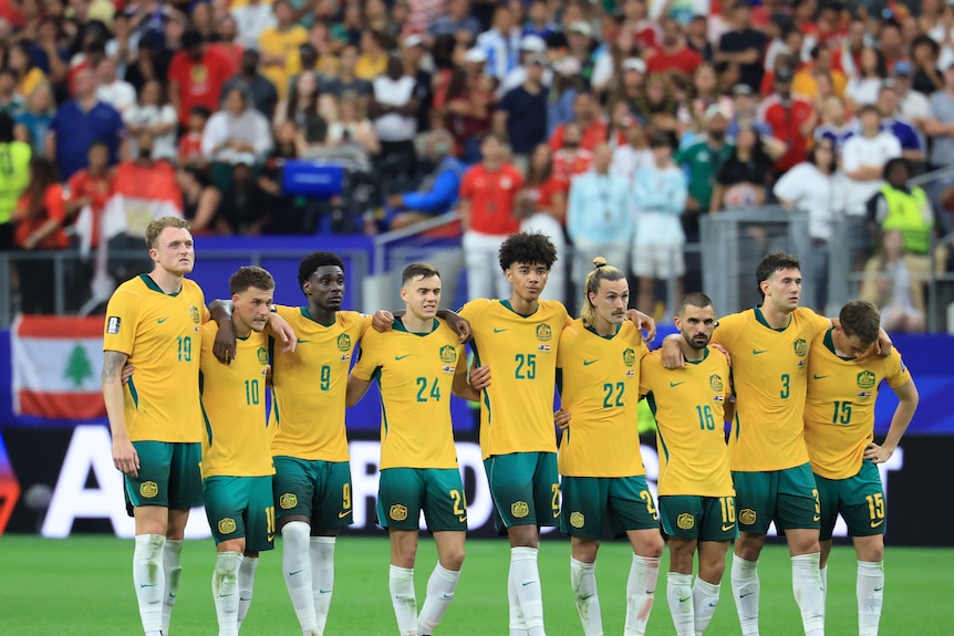The Australia team looks on during the penalty shoot out