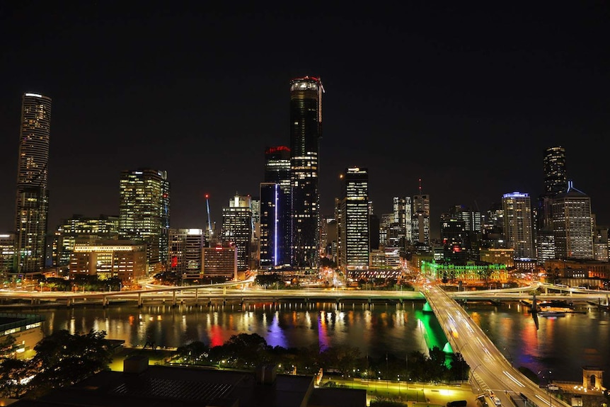 Brisbane city skyline and river lit up at night from South Brisbane.