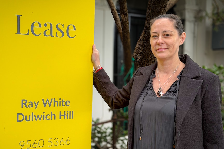 Tanja Cosic next to a yellow rental sign