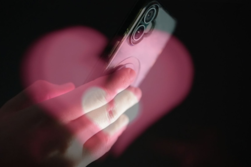Phone with a broken heart graphic