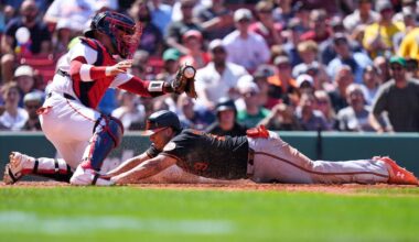 Baltimore Orioles' Samuel Basallo, right, beats the tag by Boston Red Sox's Carlos Narváez to score on a sacrifice by Colton Cowser during the fifth inning of a baseball game, Thursday, June 4, 2026, in Boston.