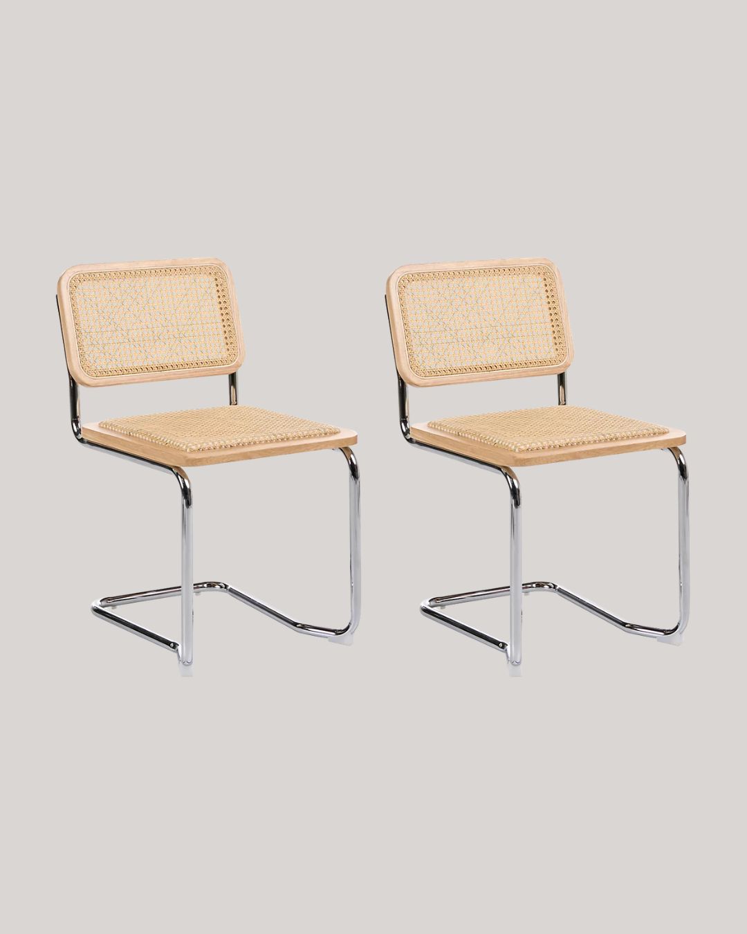 Two CORDOVA Rattan chairs with tubular chrome structure against pale gray background.