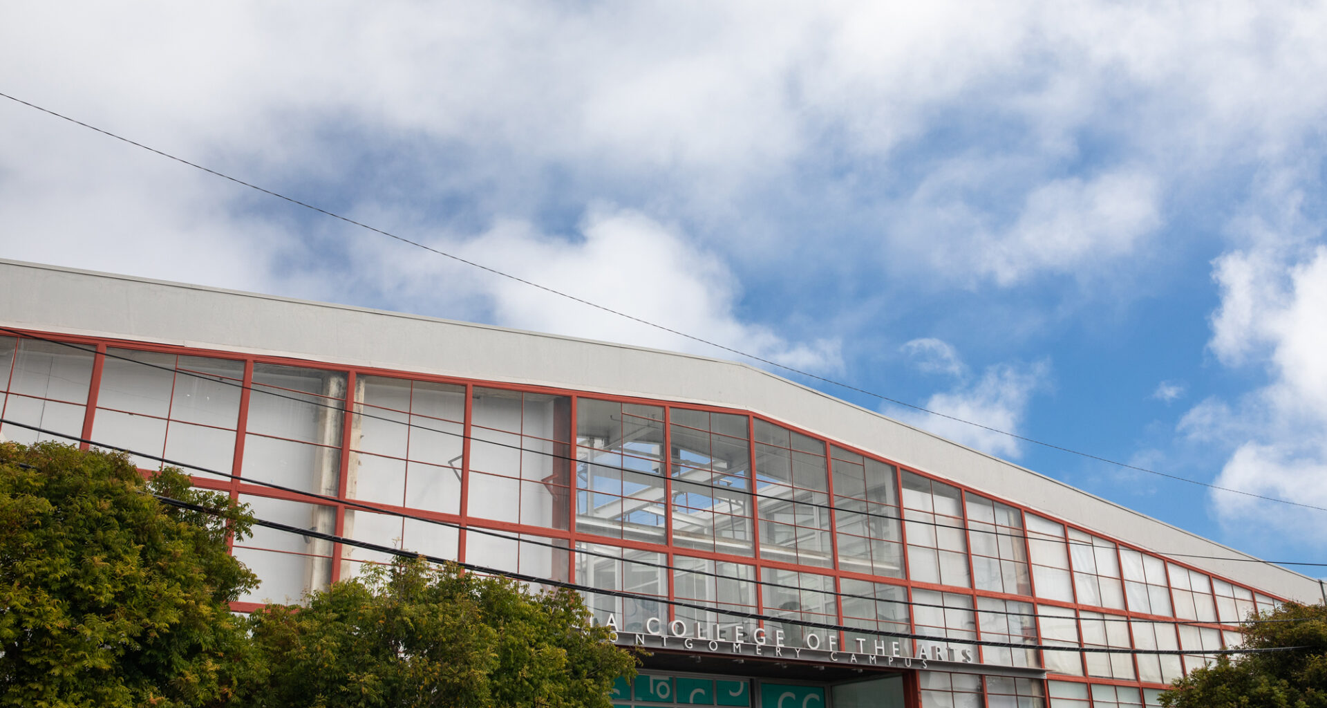 industrial roofline against puffy clouds