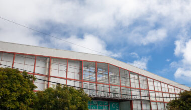 industrial roofline against puffy clouds