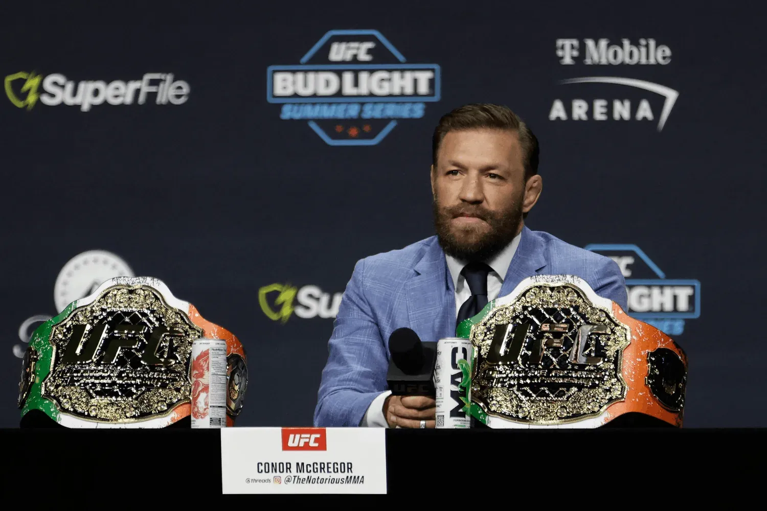 Islam Makhachev smiles while being asked questions by a reporter