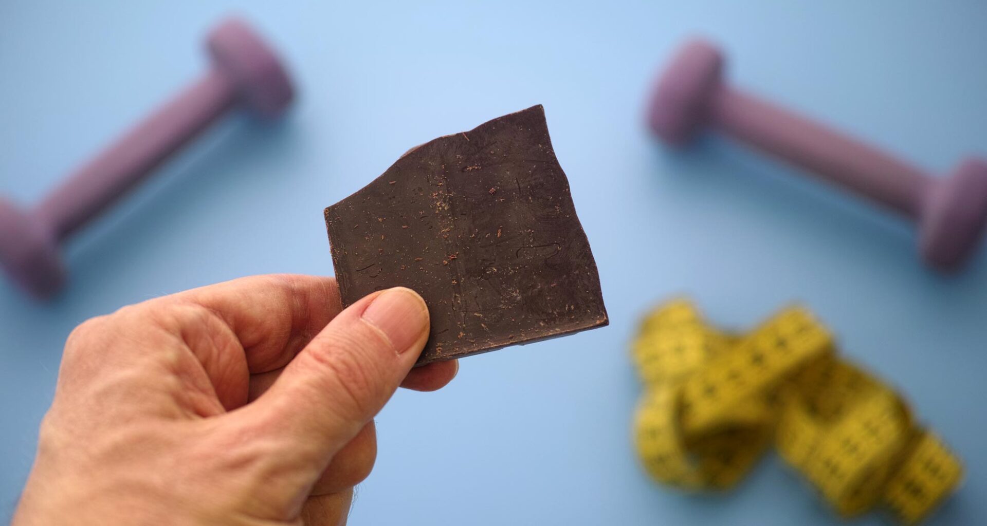 Fitness Diet Hand Holding Broken Dark Chocolate