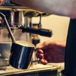 Barista hand making cappuccino Coffee with espresso machine in cafe - stock photo