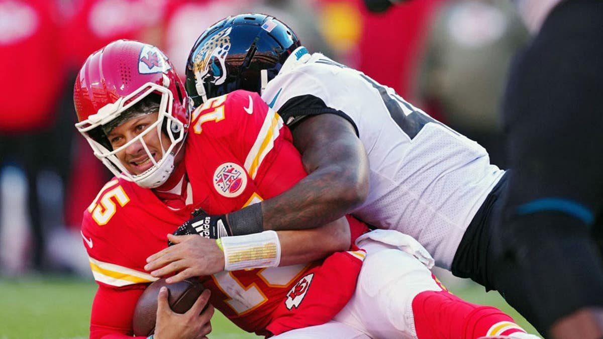 Patrick Mahomes is tackled by Josh Allen on the field at Arrowhead Stadium.