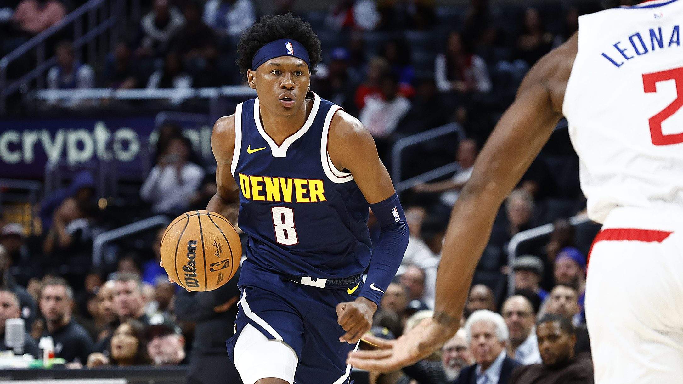 Denver Nuggets forward Peyton Watson brings the ball up the court against the Los Angeles Clippers during an NBA game.