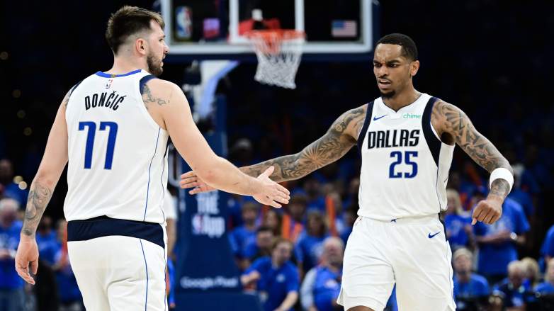 Dallas Mavericks forward PJ Washington celebrates with Luka Dončić during an NBA game.
