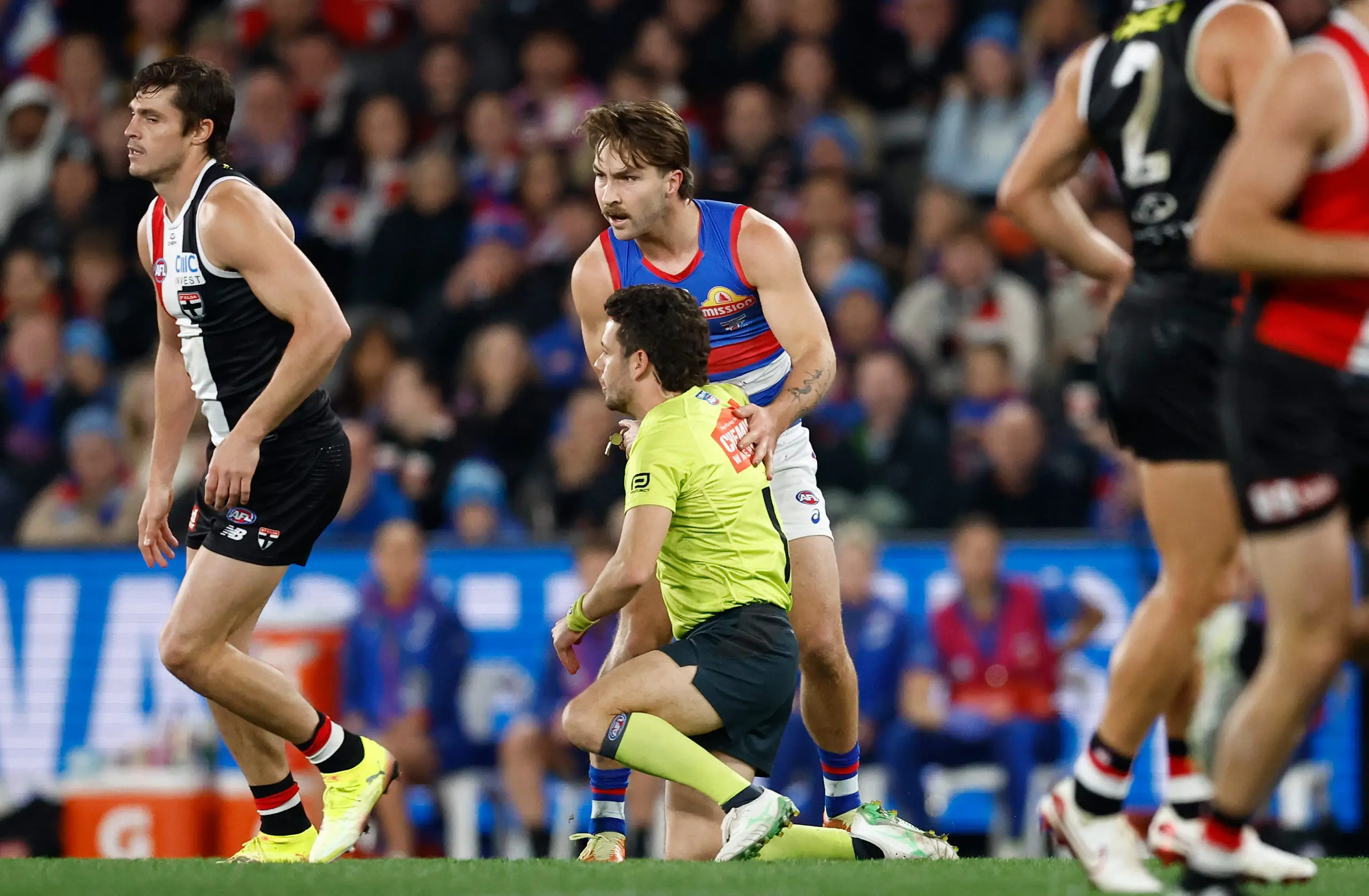 MELBOURNE, AUSTRALIA - JUNE 12: Curtis Deboy, AFL Field Umpire and Rhylee West of the Bulldogs come into contact during the 2025 AFL Round 14 match between the St Kilda Saints and the Western Bulldogs at Marvel Stadium on June 12, 2025 in Melbourne, Australia. (Photo by Michael Willson/AFL Photos via Getty Images)