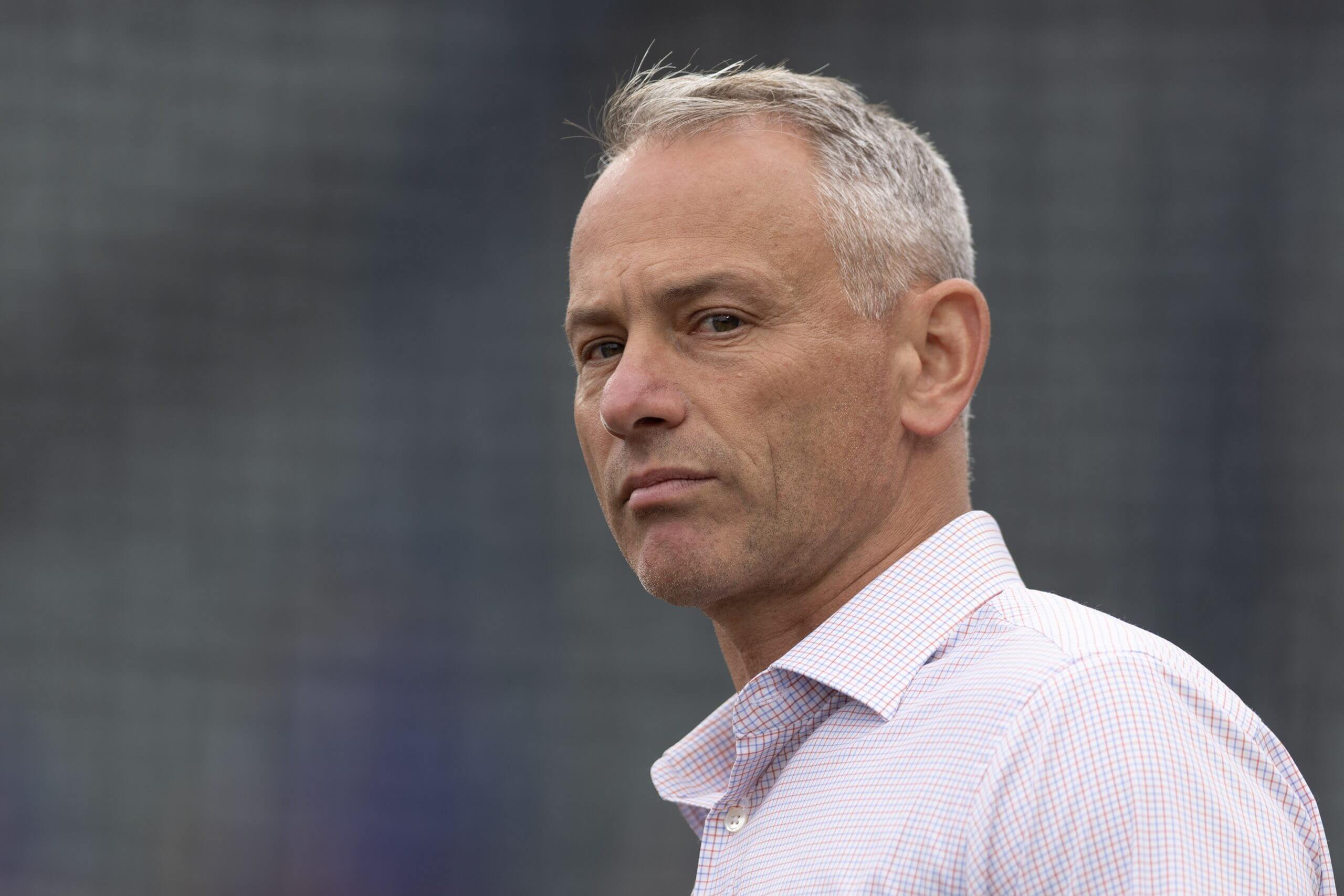 Jed Hoyer looks on. 