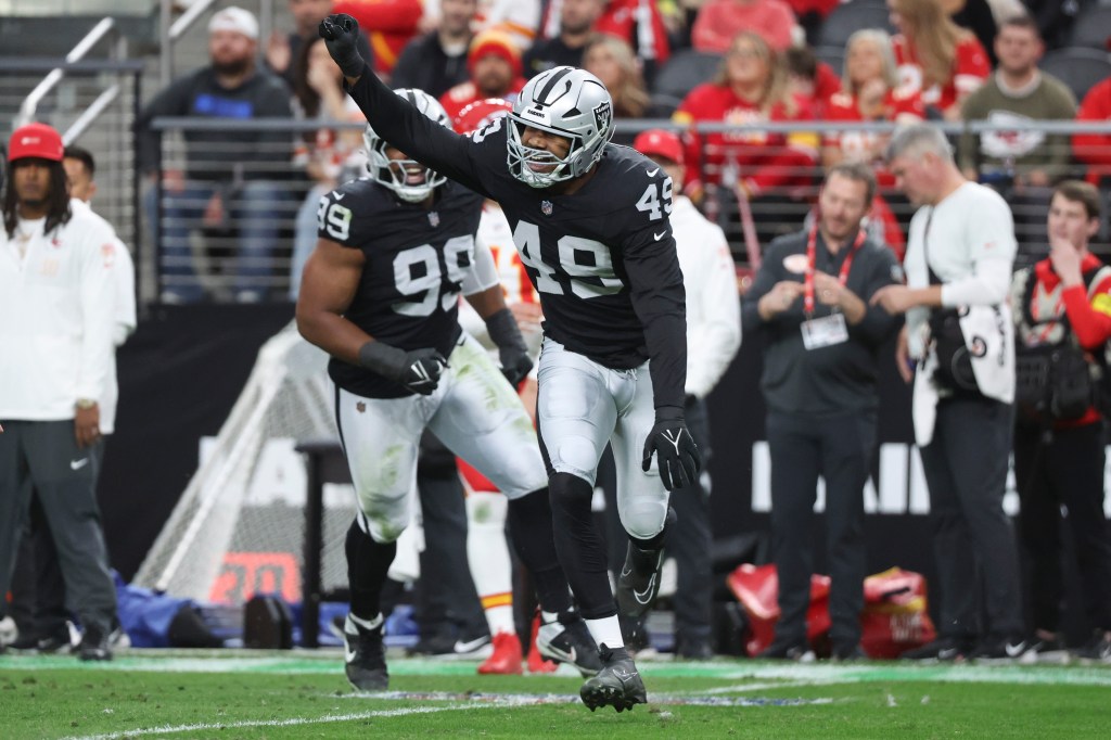 Raiders player Malcolm Koonce (#49) celebrating a play during a game against the Kansas City Chiefs.