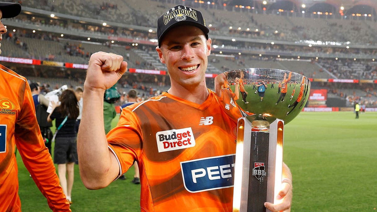 Luke Holt holds the trophy during the celebration at Perth Stadium.