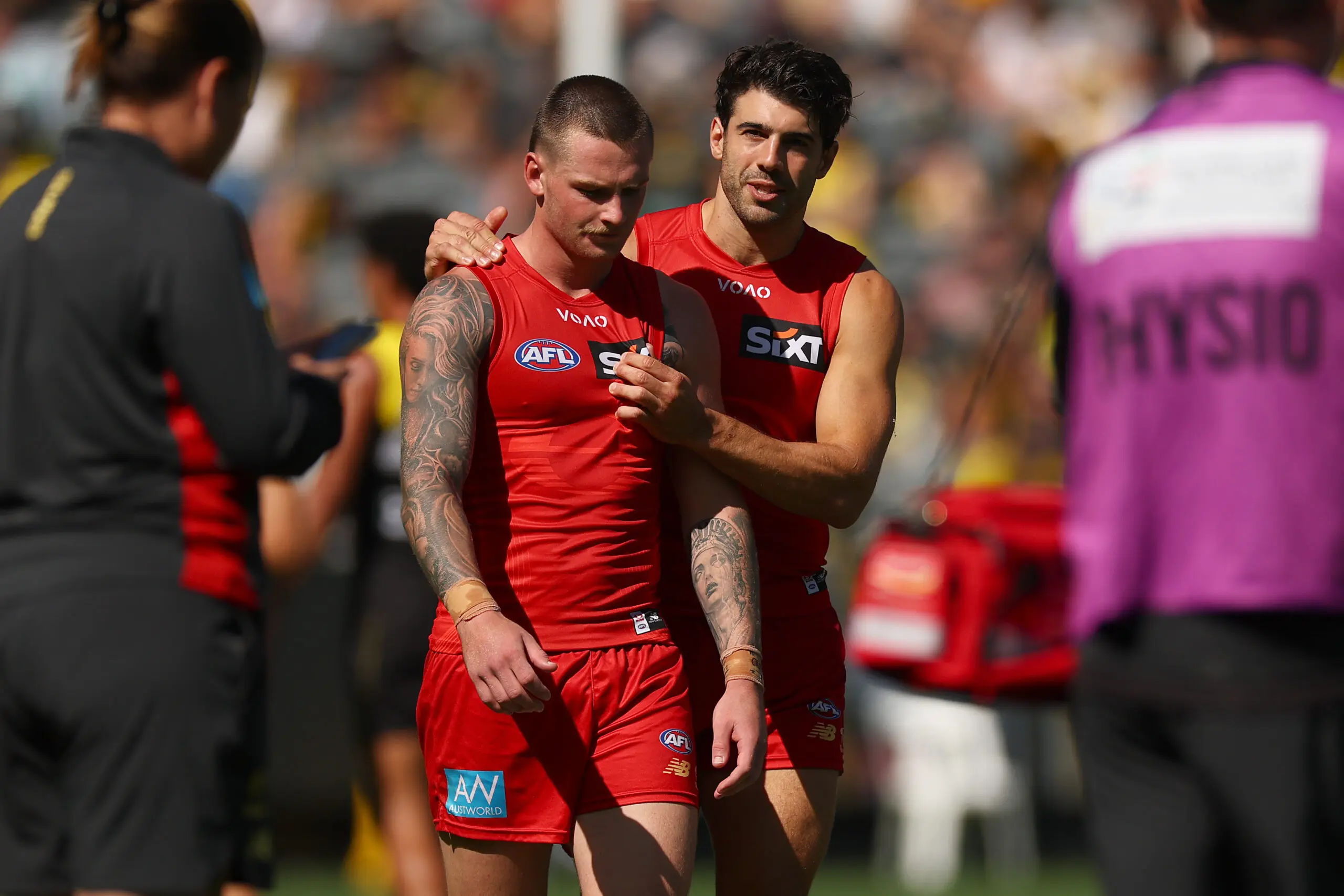 MELBOURNE, AUSTRALIA - MARCH 21: Christian Petracca of the Suns chats with Bailey Humphrey of the Suns at three quarter time during the round two AFL match between Richmond Tigers and Gold Coast Suns at Melbourne Cricket Ground, on March 21, 2026, in Melbourne, Australia. (Photo by Daniel Pockett/Getty Images)