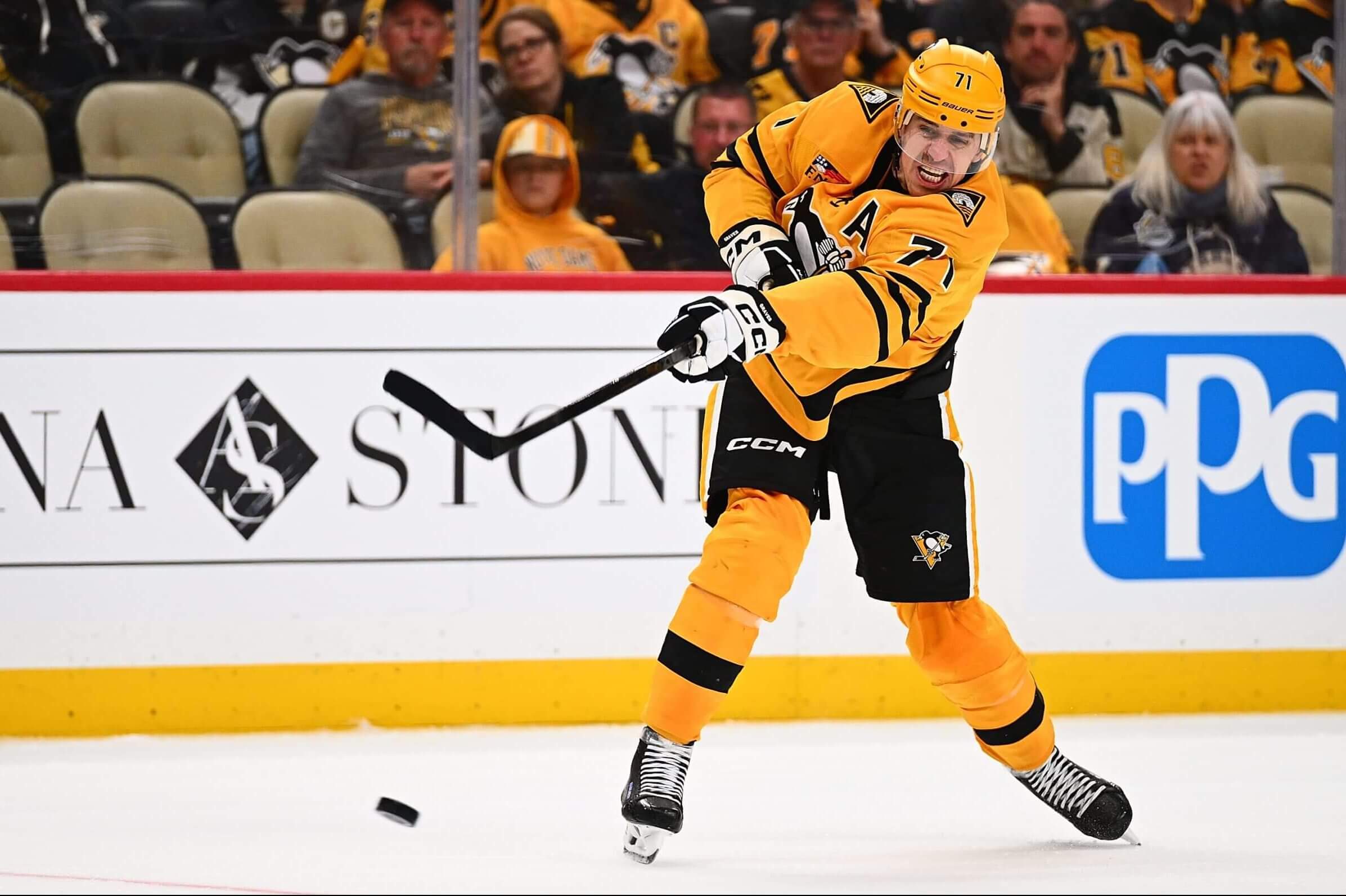 Pittsburgh Penguins center Evgeni Malkin shoots the puck during an NHL game.