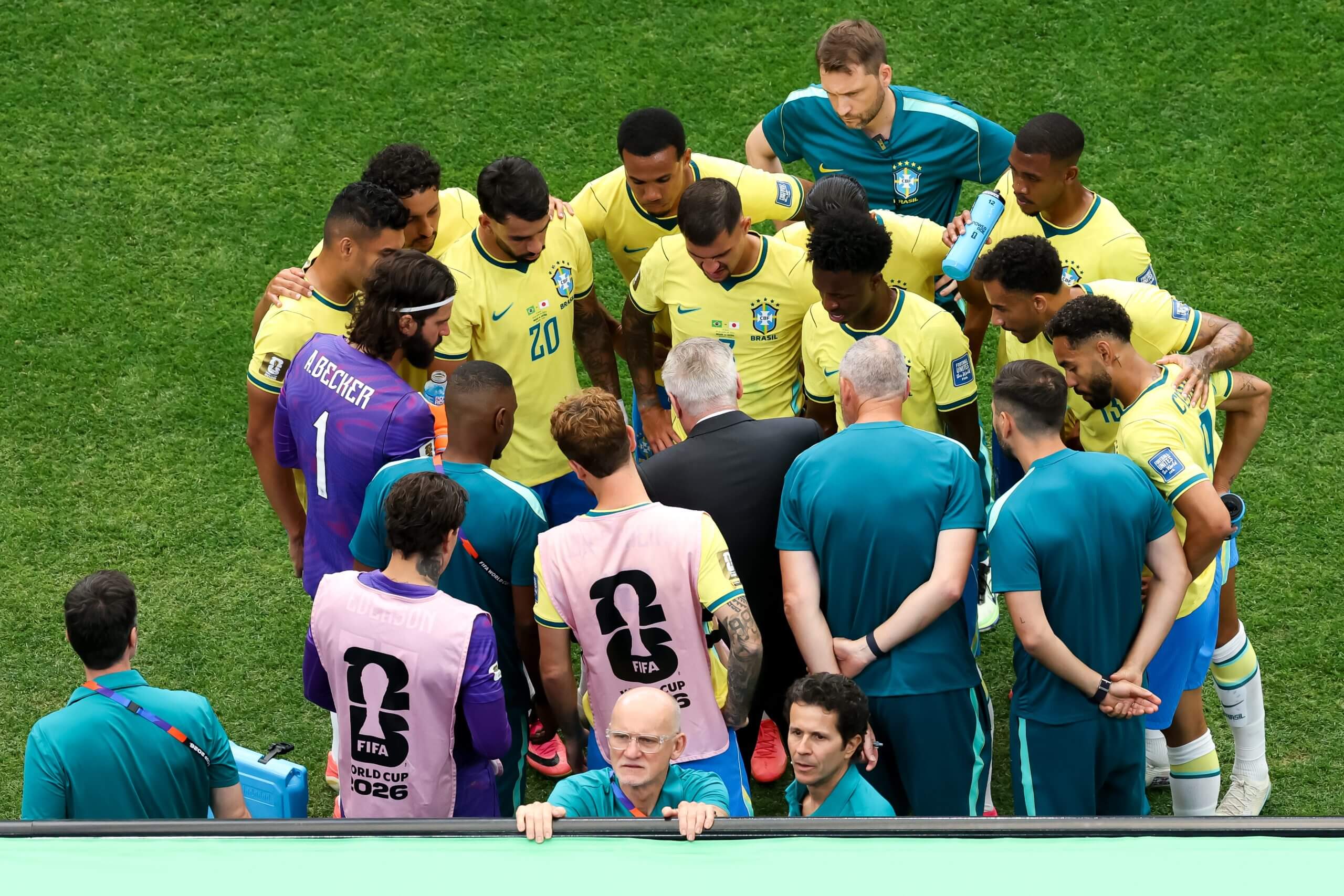 Brazil's players huddle around manager Carlo Ancelotti during a hydration break