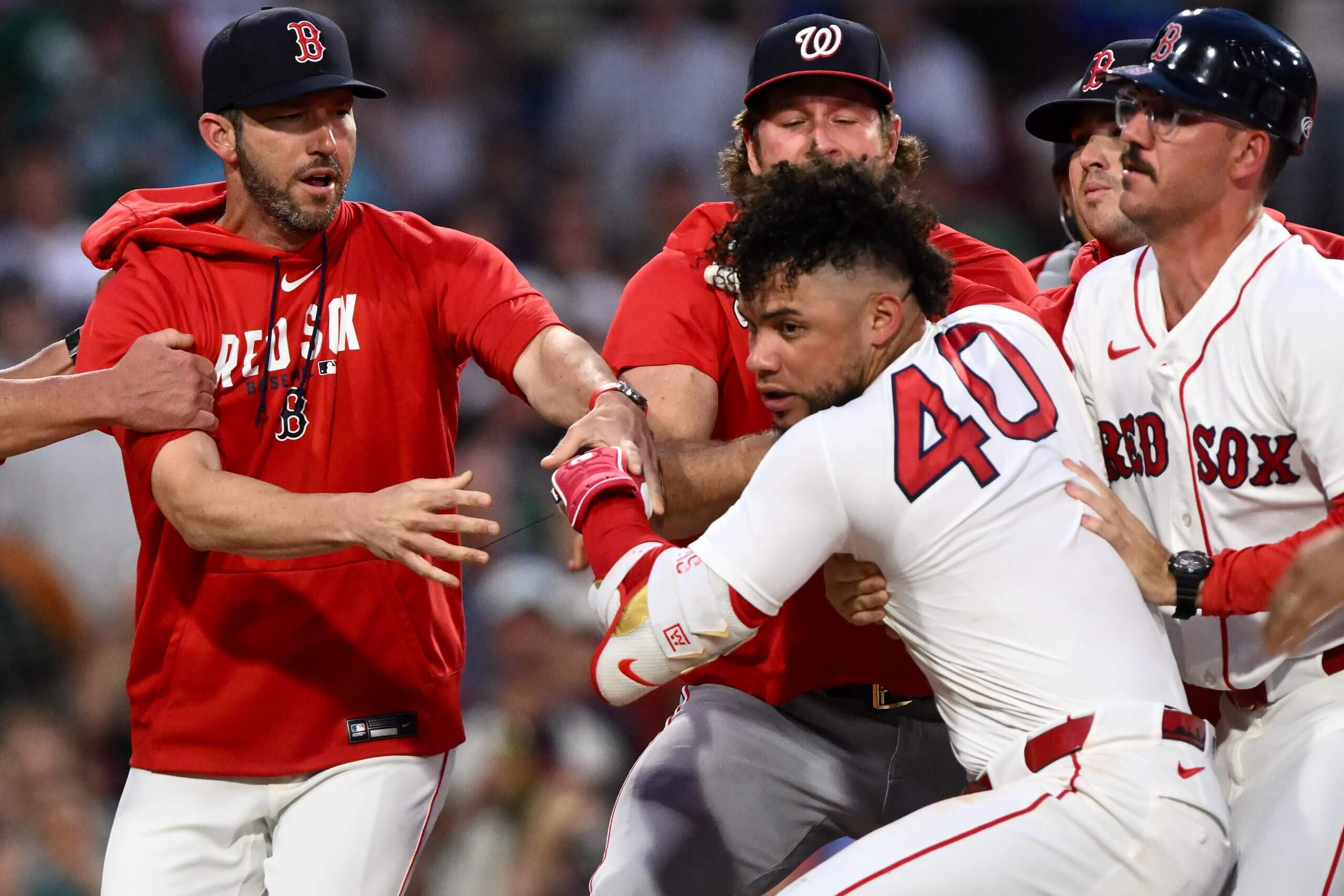 Red Sox manager Chad Tracy, left, tries to hold back Willson Contreras after an altercation with Nationals pitcher Cade Cavalli in the fourth inning Tuesday night at Fenway Park. (Brian Fluharty / Getty Images)
