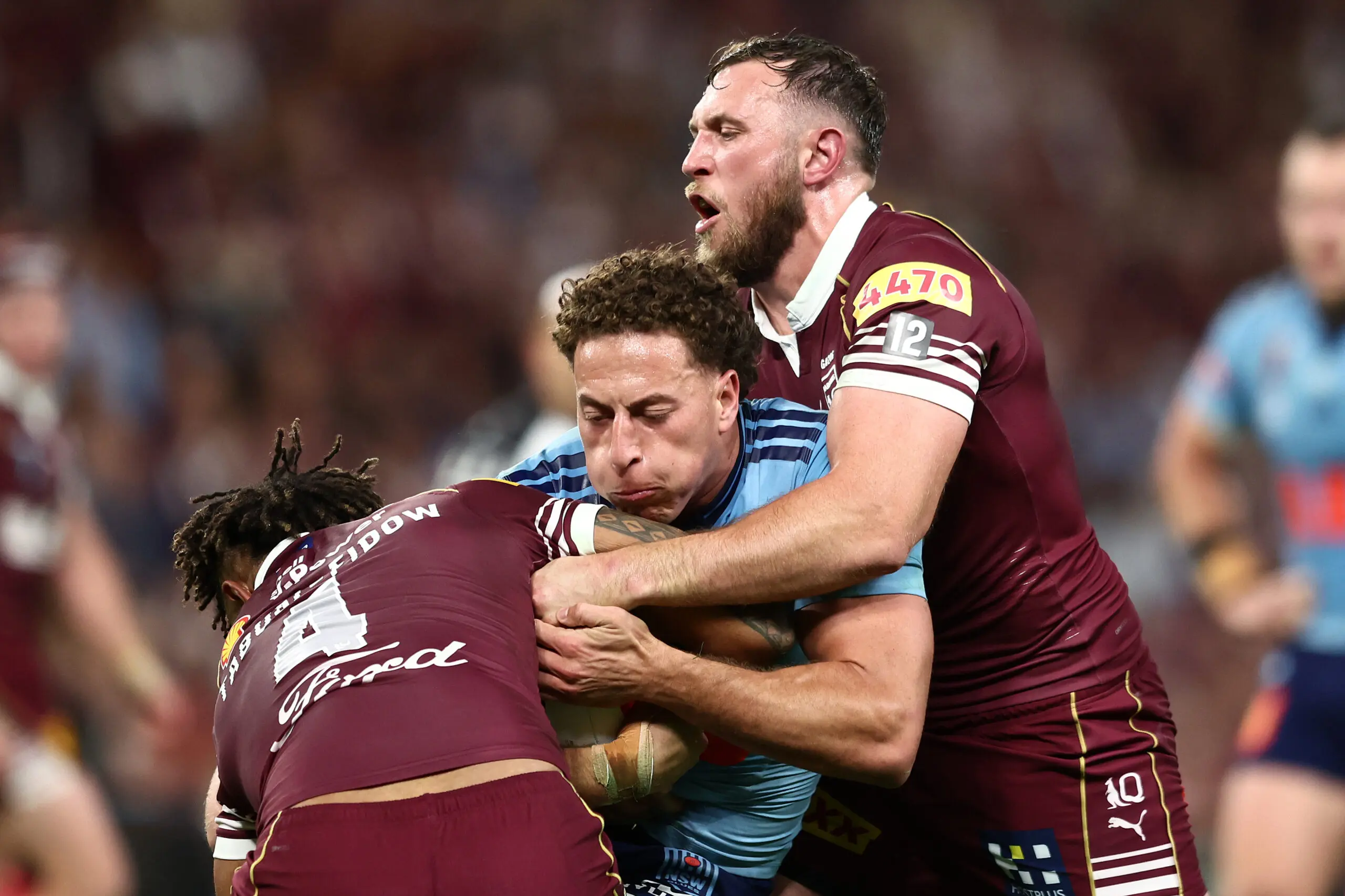 BRISBANE, AUSTRALIA - JULY 08: Mark Nawaqanitawase of the Blues is tackled by Kurt Capewell of the Maroons and Hamiso Tabuai-Fidow of the Maroons during game three of the Men's State of Origin series between the Queensland Maroons and the New South Wales Blues at Suncorp Stadium on July 08, 2026 in Brisbane, Australia. (Photo by Chris Hyde/Getty Images)