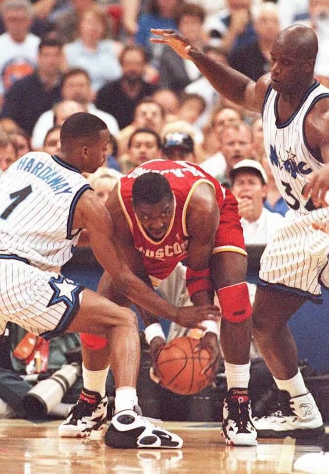 Penny Hardaway and Shaquille O'Neal defend against Hakeem Olajuwon.