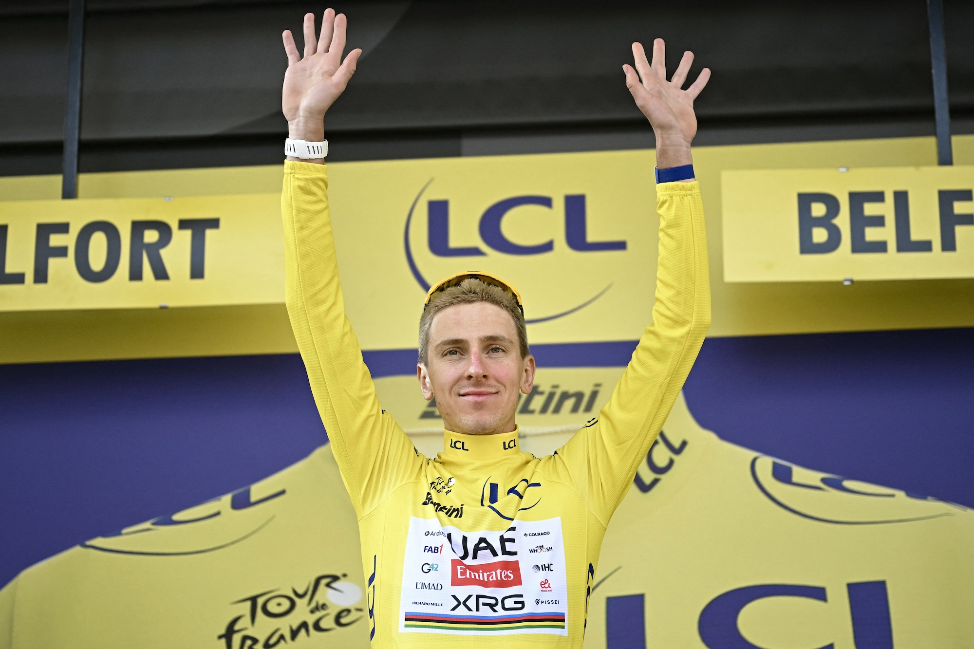 UAE Team Emirates - XRG's Slovenian rider Tadej Pogacar celebrates on the podium with the overall leader's yellow jersey after the 13th stage of the 113th edition of the Tour de France cycling race, 205,8 km between Dole and Belfort in eastern France, on July 17, 2026. (Photo by Loic VENANCE / AFP)