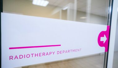Sign "radiotherapy department" is visible in the hospital corridor. The sign indicates the direction of movement to the medical department of radiation therapy