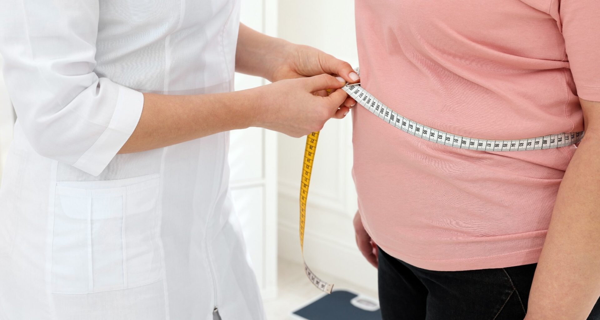 Nutritionist measuring overweight woman