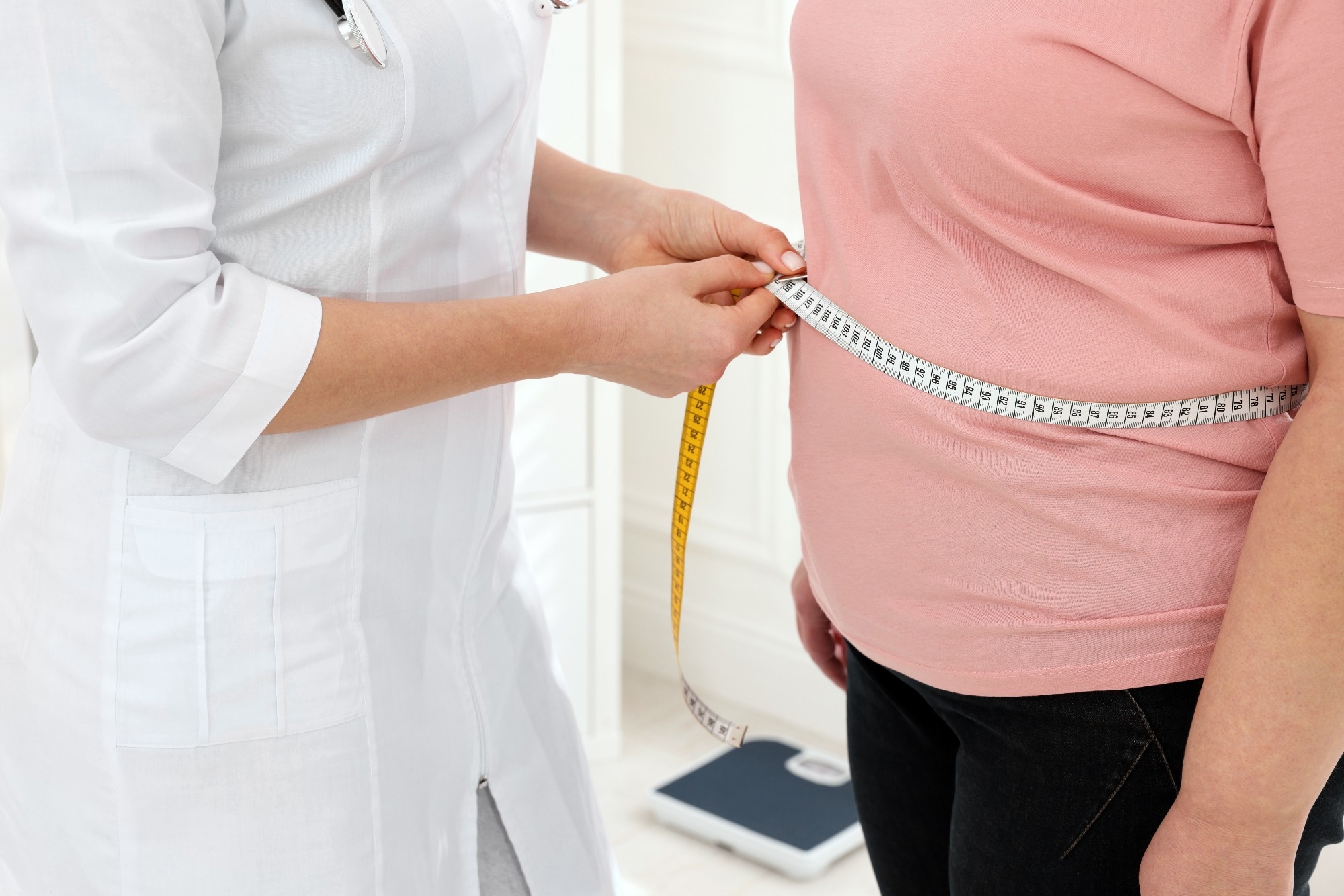 Nutritionist measuring overweight woman
