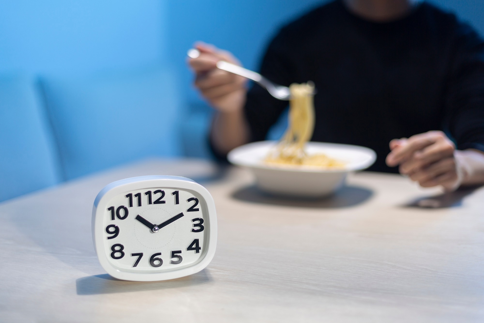Man eating late night time alone at home or apartment scene.