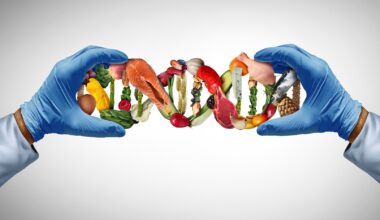 **Alt text:** Laboratory-gloved hands hold a DNA strand made of healthy foods, illustrating the relationship between genetics, nutrition and obesity research.