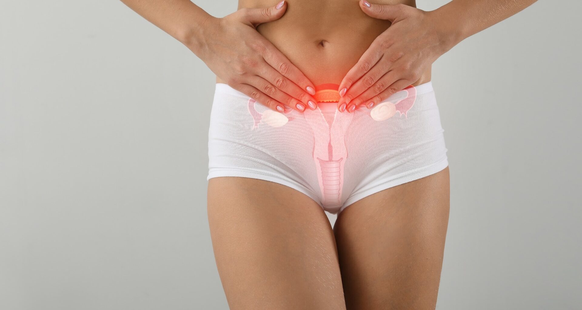 Young woman with drawing of reproductive system on light background. Gynecology concept