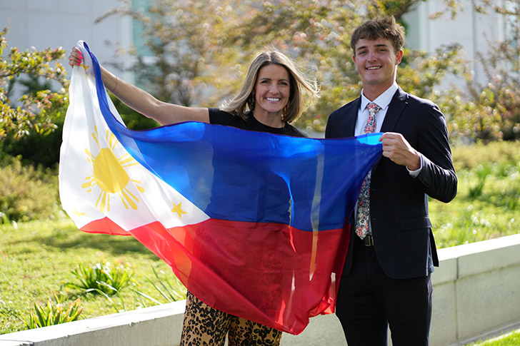Missionary JJ Tomsick stands with a family member holding the flag of the Philippines after accepting his Mission call to the Philippines Olongapo Mission. In his missionary farewell talk, he explains how Jesus Christ and the Atonement of Jesus Christ changed his heart and inspired him to serve a Mission.