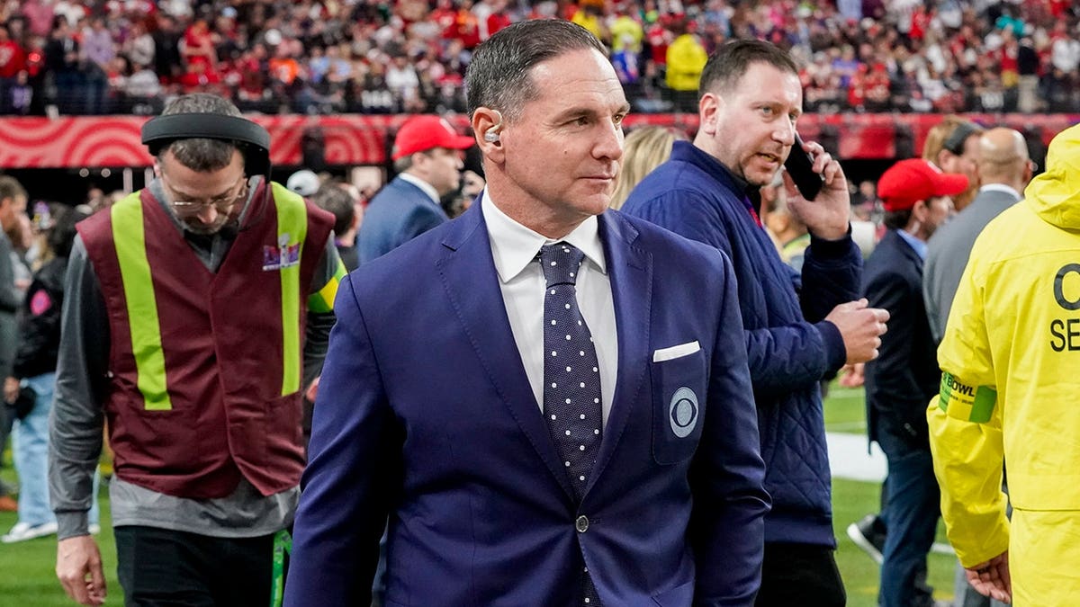 Jay Feely walks on the Allegiant Stadium sideline