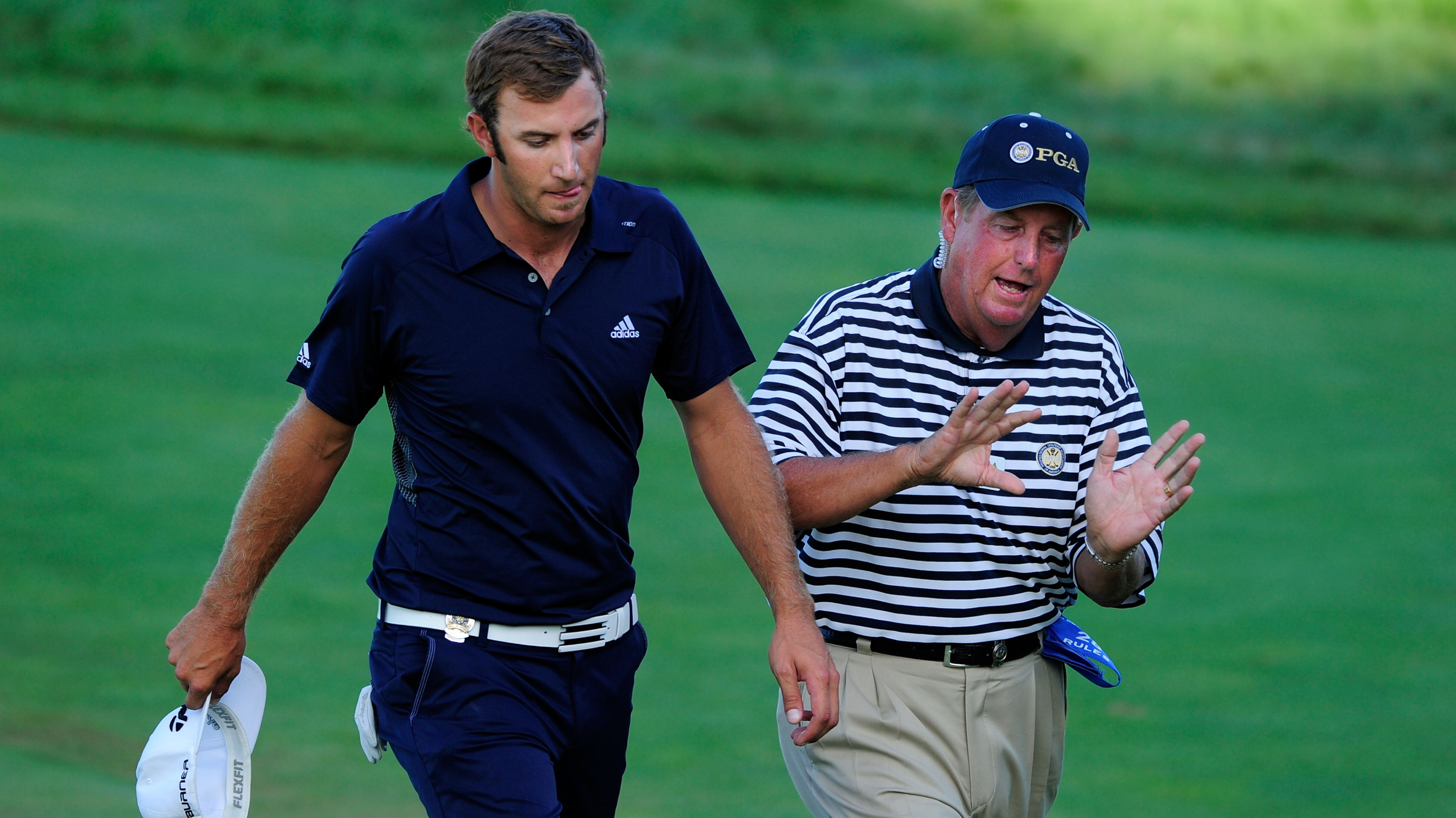 Dustin Johnson speaks to a rules official at the 2010 PGA Championship