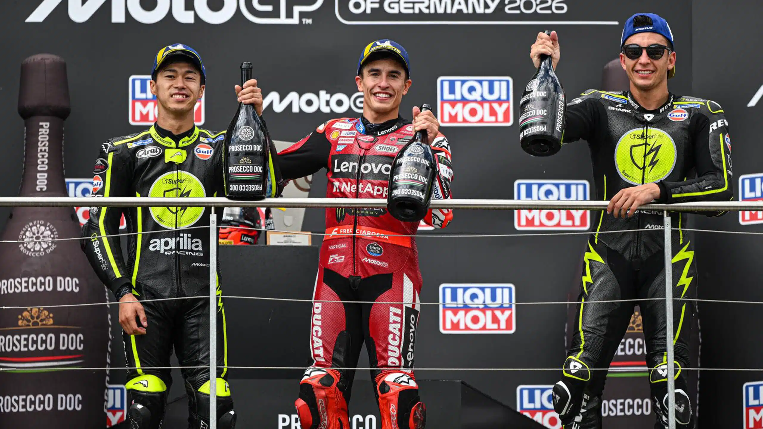 Marc Marquez on MotoGP podium with Ai Ogura and Raul Fernandez
