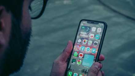 Person Looking at iPhone featured