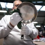 An employee of the French pan maker Cristel, wipes a frying pan at the Cristel factory, on May 23, 2024, in Fesches-le-Chatel, eastern France. At Fesches-le-Chatel, in the Doubs region of France, the Cristel factory is on a roll: France's number-one manufacturer of stainless steel kitchen equipment has seen "demand explode" since the National Assembly passed a law restricting the use of PFAS in April. (Photo by SEBASTIEN BOZON / AFP) (Photo by SEBASTIEN BOZON/AFP via Getty Images)
