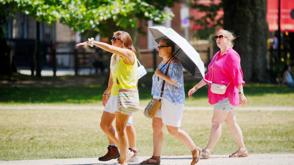 People enjoying the warm weather in Queen Square, Bristol. The heatwave across the UK looks set to continue as 2026 became the first year to record temperatures of 35C on six separate days. Picture date: Sunday July 12, 2026. PA Photo. Photo credit should read: Ben Birchall/PA Wire