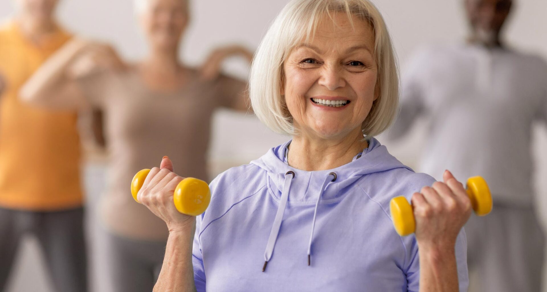 Senior Group Exercising With Weights
