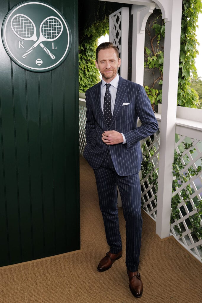  Tom Hiddleston, wearing Ralph Lauren, attends the Ralph Lauren suite during The Championships, Wimbledon 
