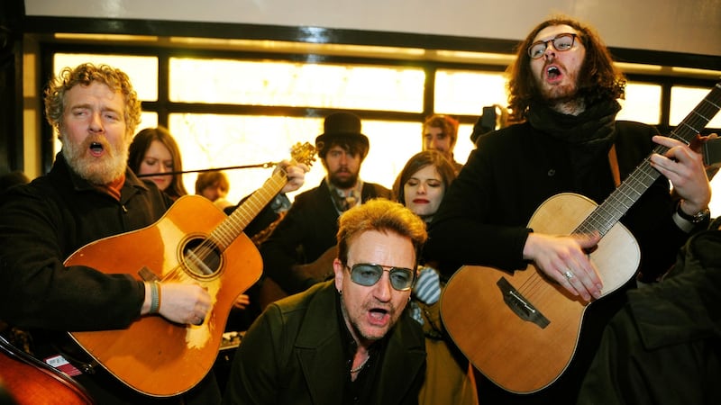 Glen Hansard, Bono and Hozier singing on Grafton Street on Christmas Eve, 2001. Photograph: Aidan Crawley/The Irish Times