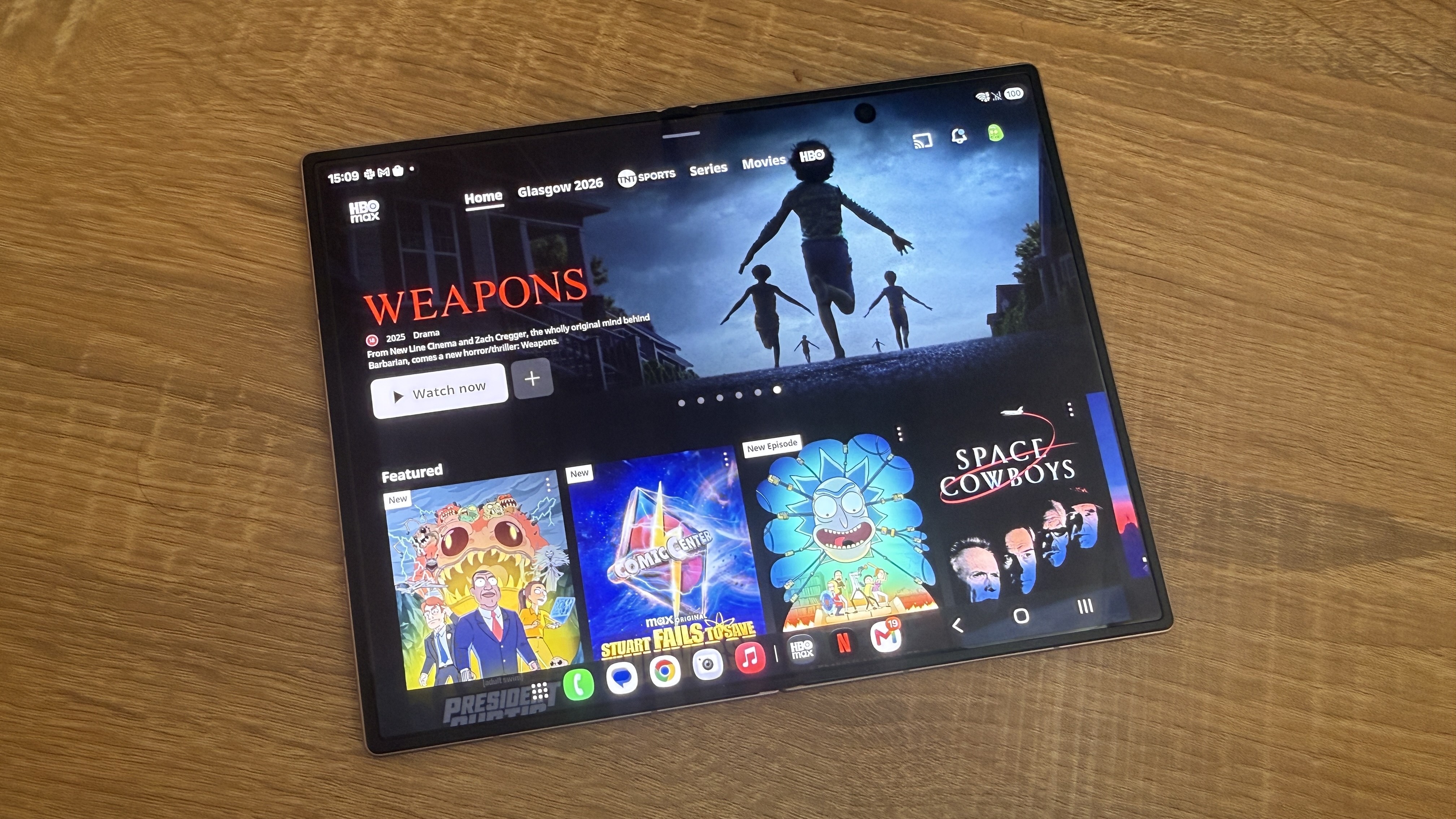 A Samsung Galaxy Z Fold 8 smartphone with the HBO Max home menu on screen