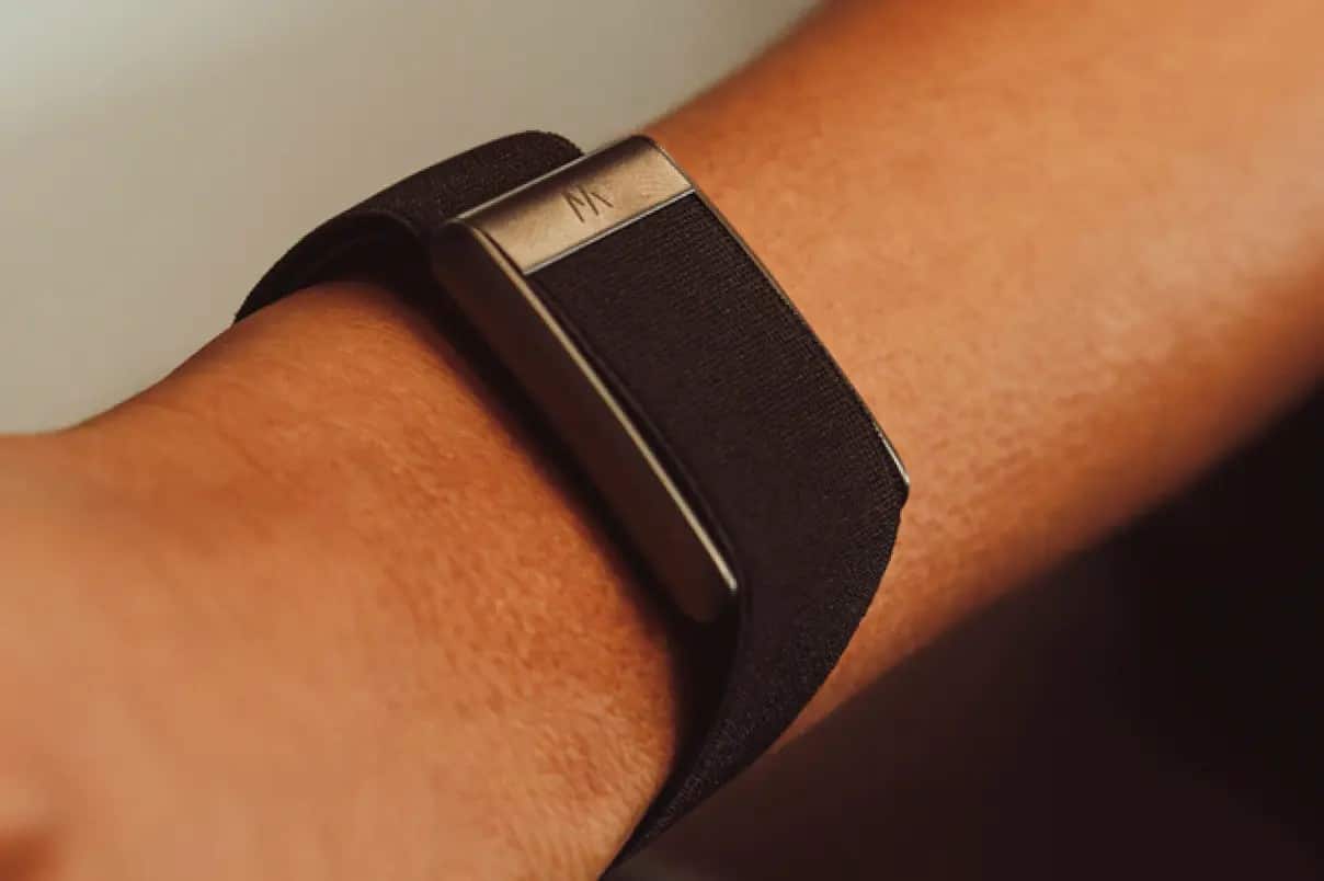 WHOOP 5.0 fitness tracker worn on a wrist with a black band