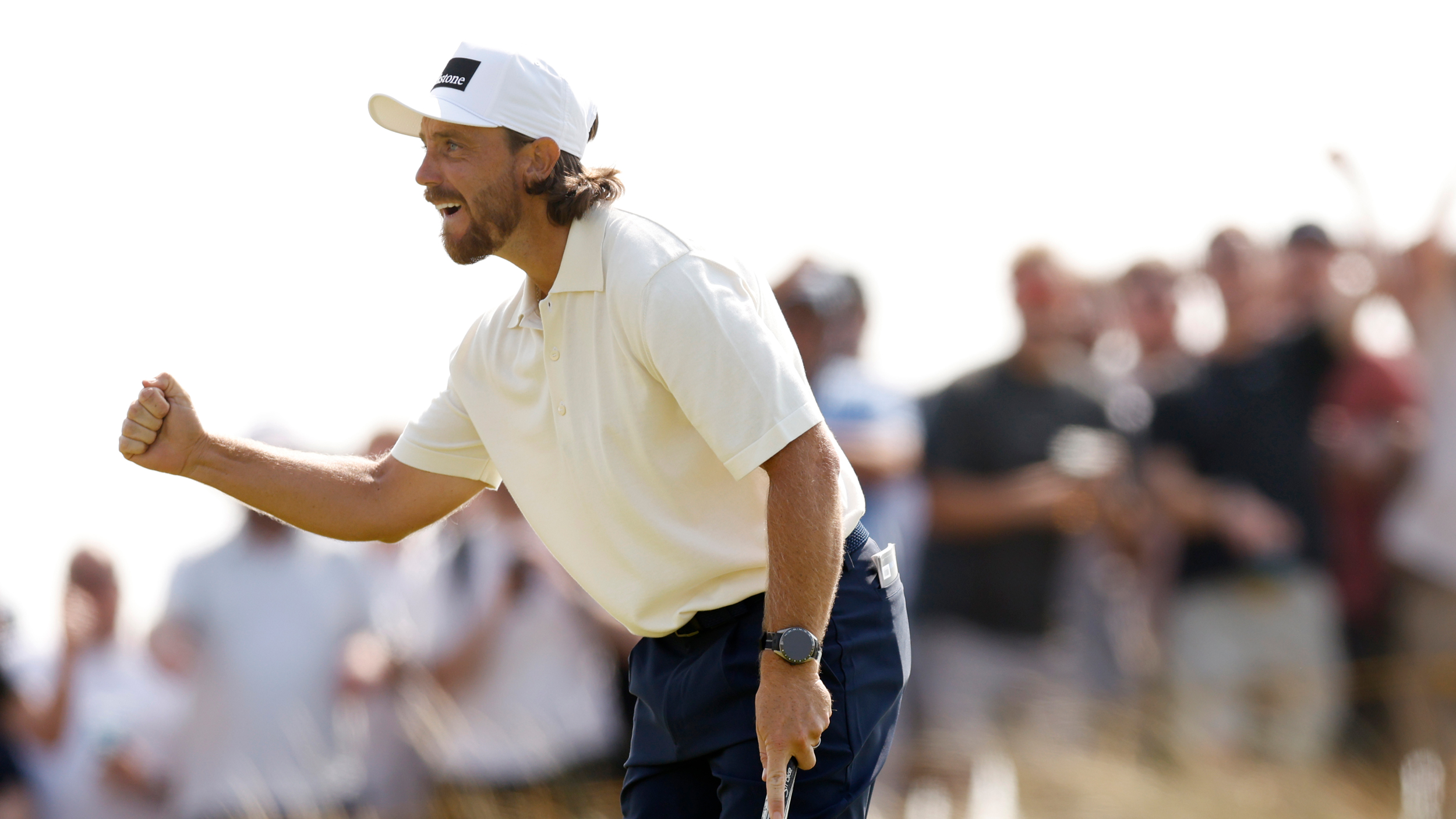 Tommy Fleetwood fist pumps holing a putt at The Open