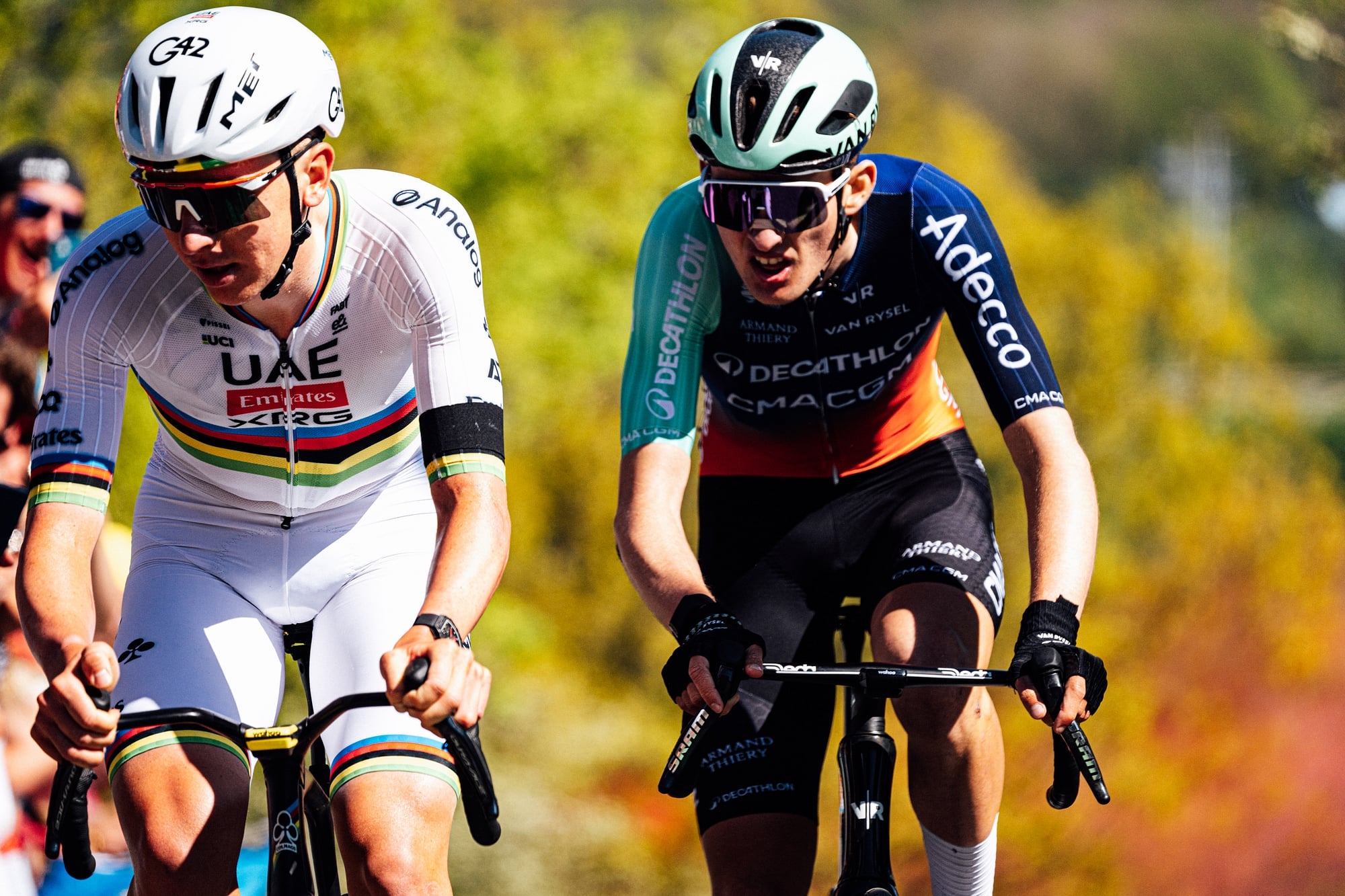 Paul Seixas of Decathlon-CMA CGM rides alongside Tadej Pogačar on a climb