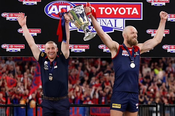 Goodwin and Demons captain Max Gawn lift the 2021 premiership cup aloft.