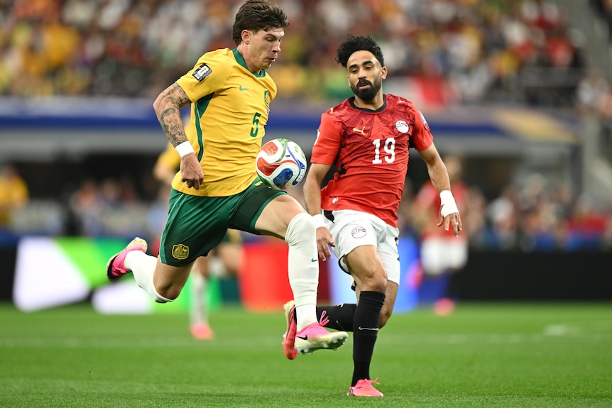 Jordy Bos makes a run with the ball ahead of a defender