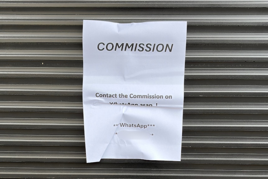 A note posted on a roller door.