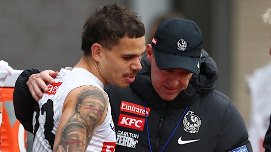 Love and care: Bobby Hill with Collingwood coach Craig McRae.