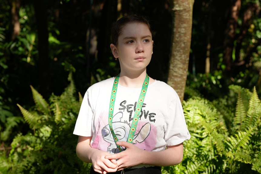 Girl with brown hair and a white t-shirt